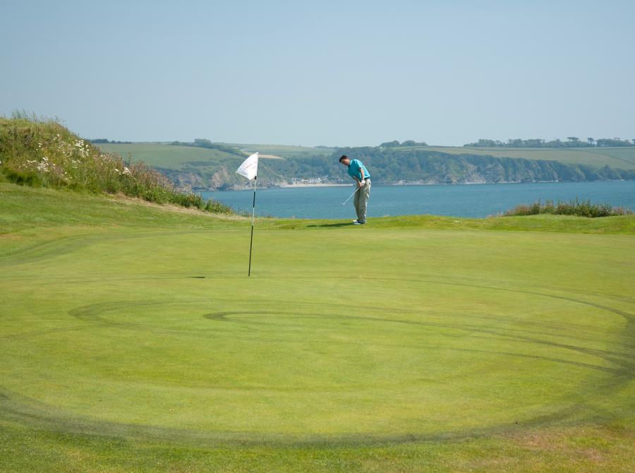 9th green with view of polkerris in distance